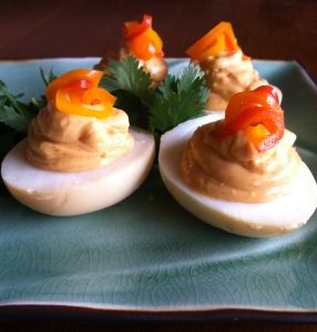 Yolks mashed with roasted garlic, smoked paprika, mayo, and hot sauce. Pickled sweet peppers on top.
